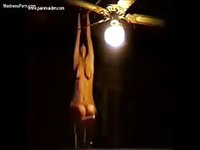 Amateur brunette coed in BDSM restraints screaming as she hangs from the ceiling nude
