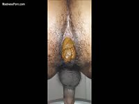 Ebony dude lets his cock hang while taking a poop on cam