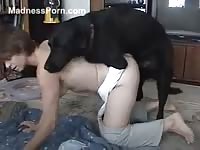 Dark-haired chick is having lots of fun with a dog