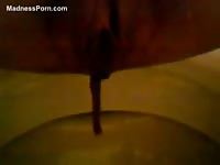 Closeup runny scat flowing into the toilet in this amateur movie